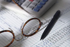 Recuperación del IVA devengado en el concurso de acreedores Una calculadora, unas gafas y un bolígrafo sobre una hoja con datos.