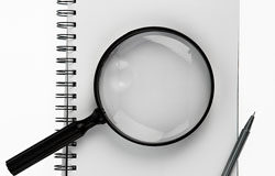 Las claves del nuevo reglamento de AEADE Una lupa sobre un cuaderno.