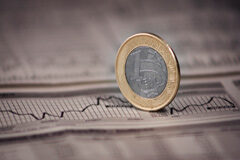 La tributación indirecta de la transmisión de valores Una moneda sobre un gráfico