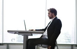 La relación laboral especial de los abogados sin convenio colectivo específico Un ejecutivo delante de su portatil en una oficina.